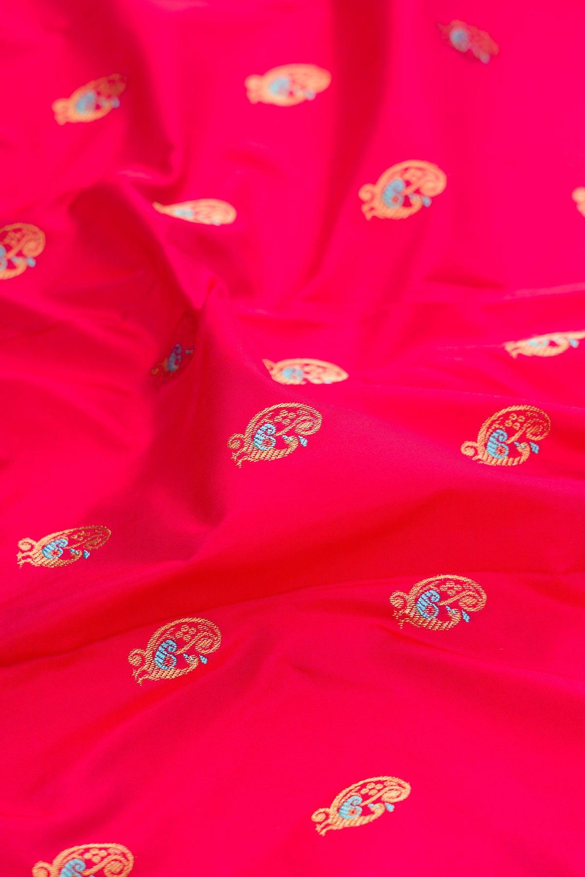 Close up of Pure Silk Pink Dual Tone Paithani Saree with Zari And Thread Butta on the body and Zari Border.  displaying folds