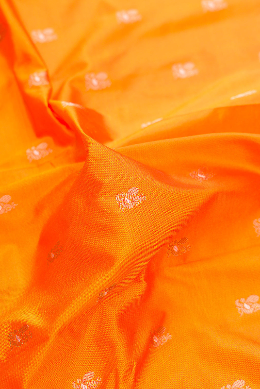 Close up of Pure Silk Orange Paithani Saree with Zari Butta on the body and Zari Border.  displaying folds