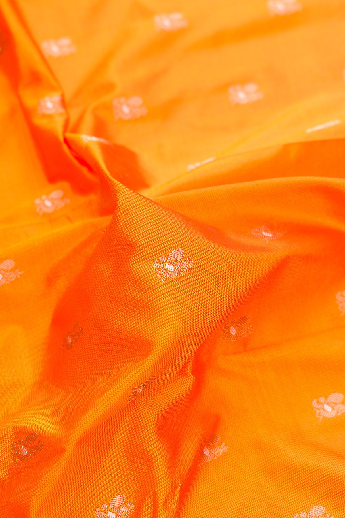 Close up of Pure Silk Orange Paithani Saree with Zari Butta on the body and Zari Border.  displaying folds