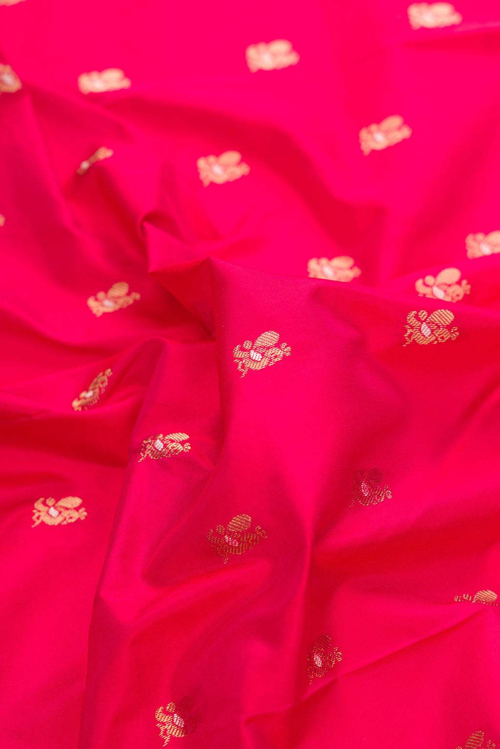 Close up of Pure Silk Dark Pink Paithani Saree with Zari Butta on the body and Zari Border.  displaying folds