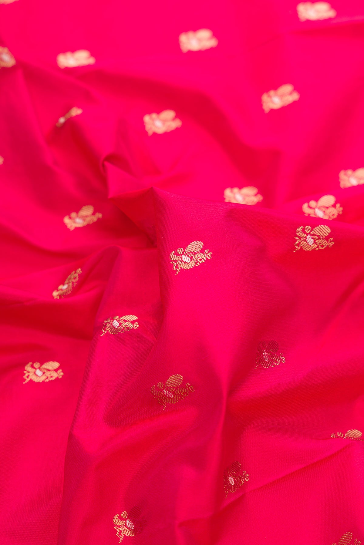 Close up of Pure Silk Dark Pink Paithani Saree with Zari Butta on the body and Zari Border.  displaying folds