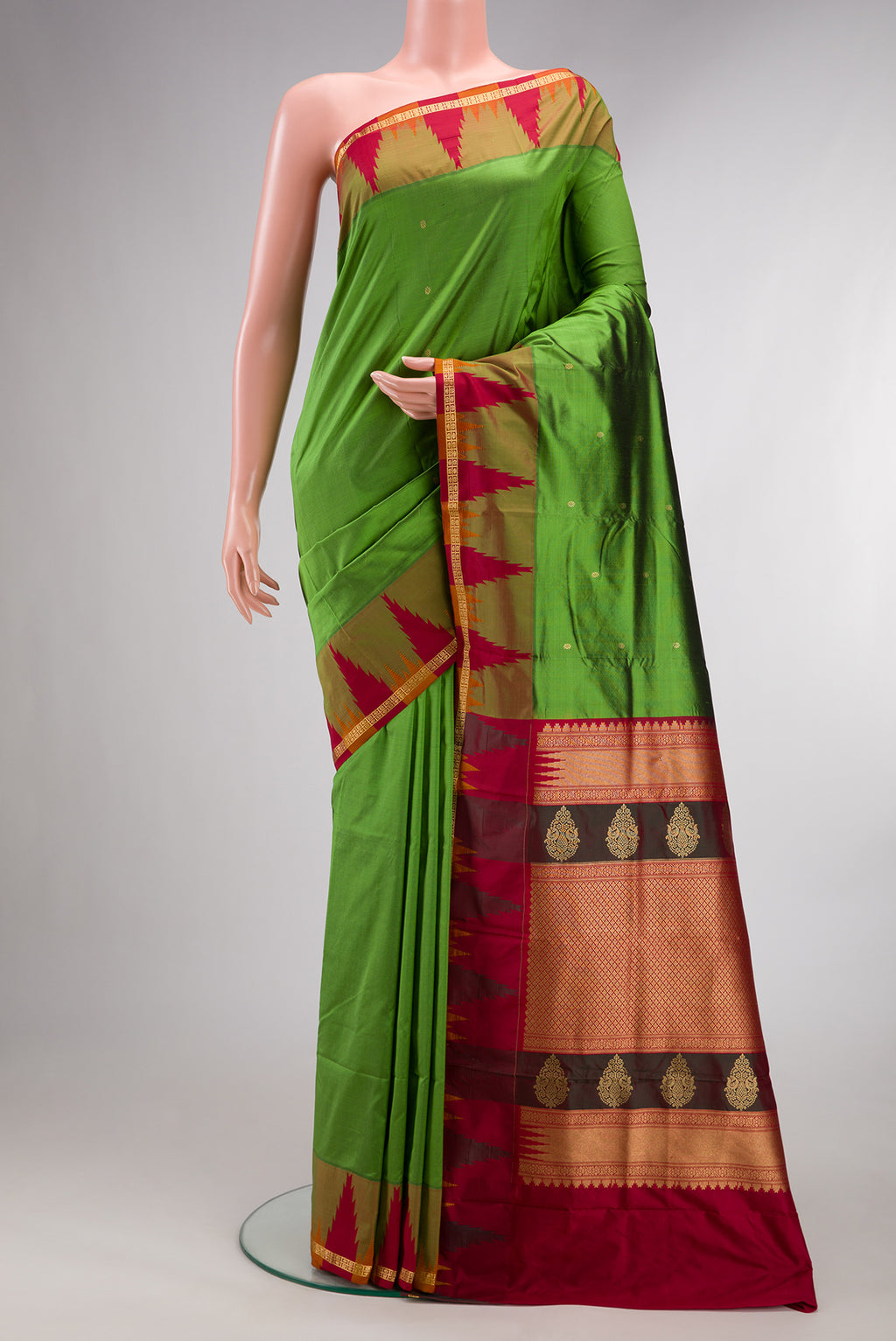 Pure Silk Green Bangalore Saree with Zari Butta on the body and Temple Border.  displayed on a mannequin