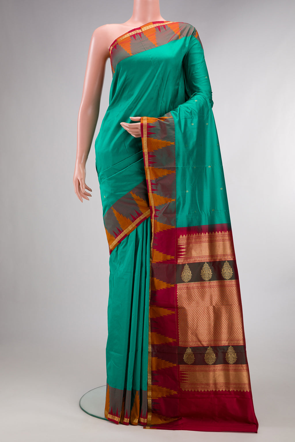 Pure Silk Green Bangalore Saree with Zari Butta on the body and Temple Border.  displayed on a mannequin