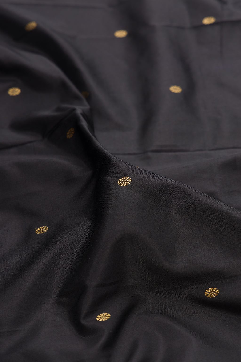 Close up of Pure Silk Black Bangalore Saree with Zari Butta on the body and Temple Border.  displaying folds