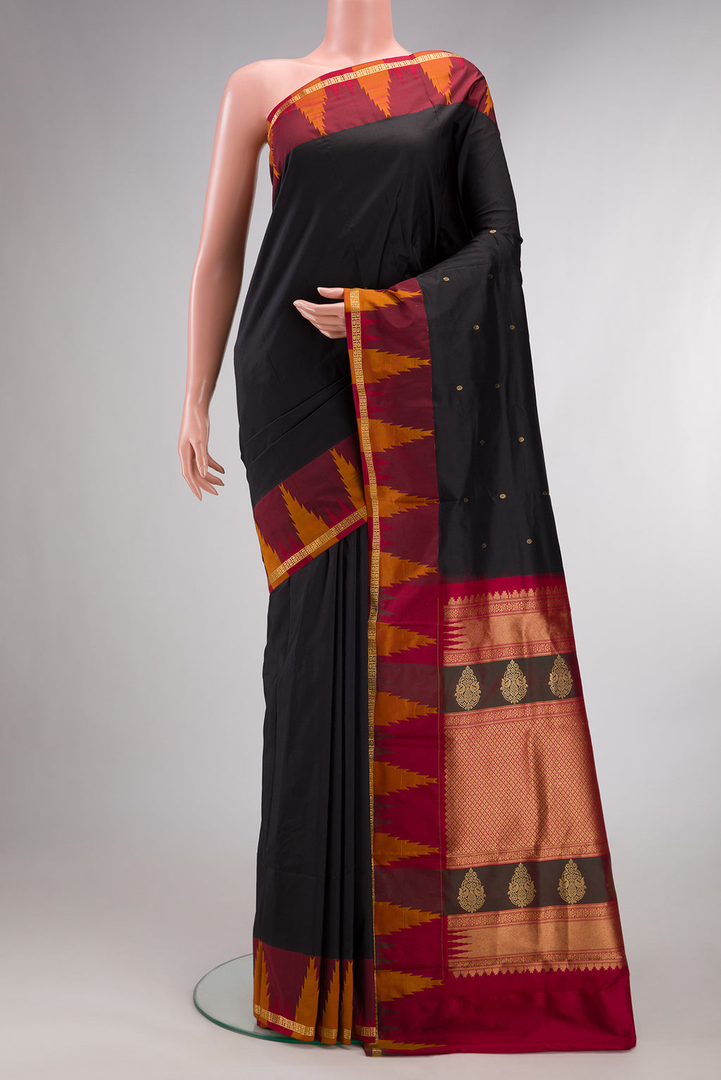 Pure Silk Black Bangalore Saree with Zari Butta on the body and Temple Border.  displayed on a mannequin