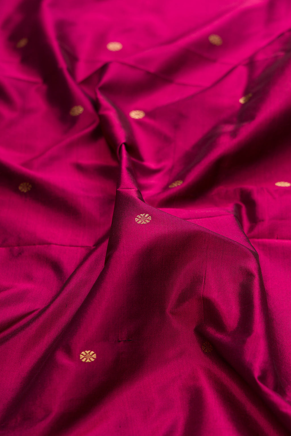 Close up of Pure Silk Magenta Bangalore Saree with Zari Butta on the body and Temple Border.  displaying folds
