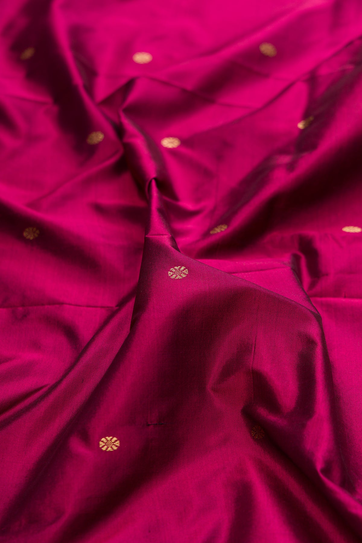 Close up of Pure Silk Magenta Bangalore Saree with Zari Butta on the body and Temple Border.  displaying folds