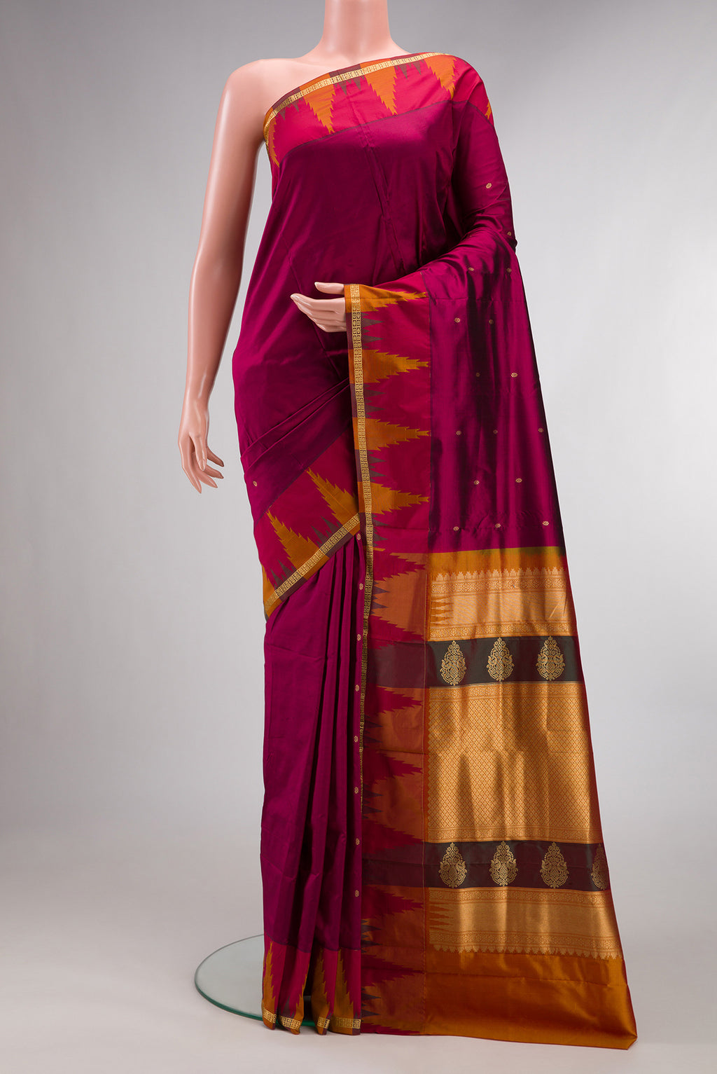 Pure Silk Magenta Bangalore Saree with Zari Butta on the body and Temple Border.  displayed on a mannequin