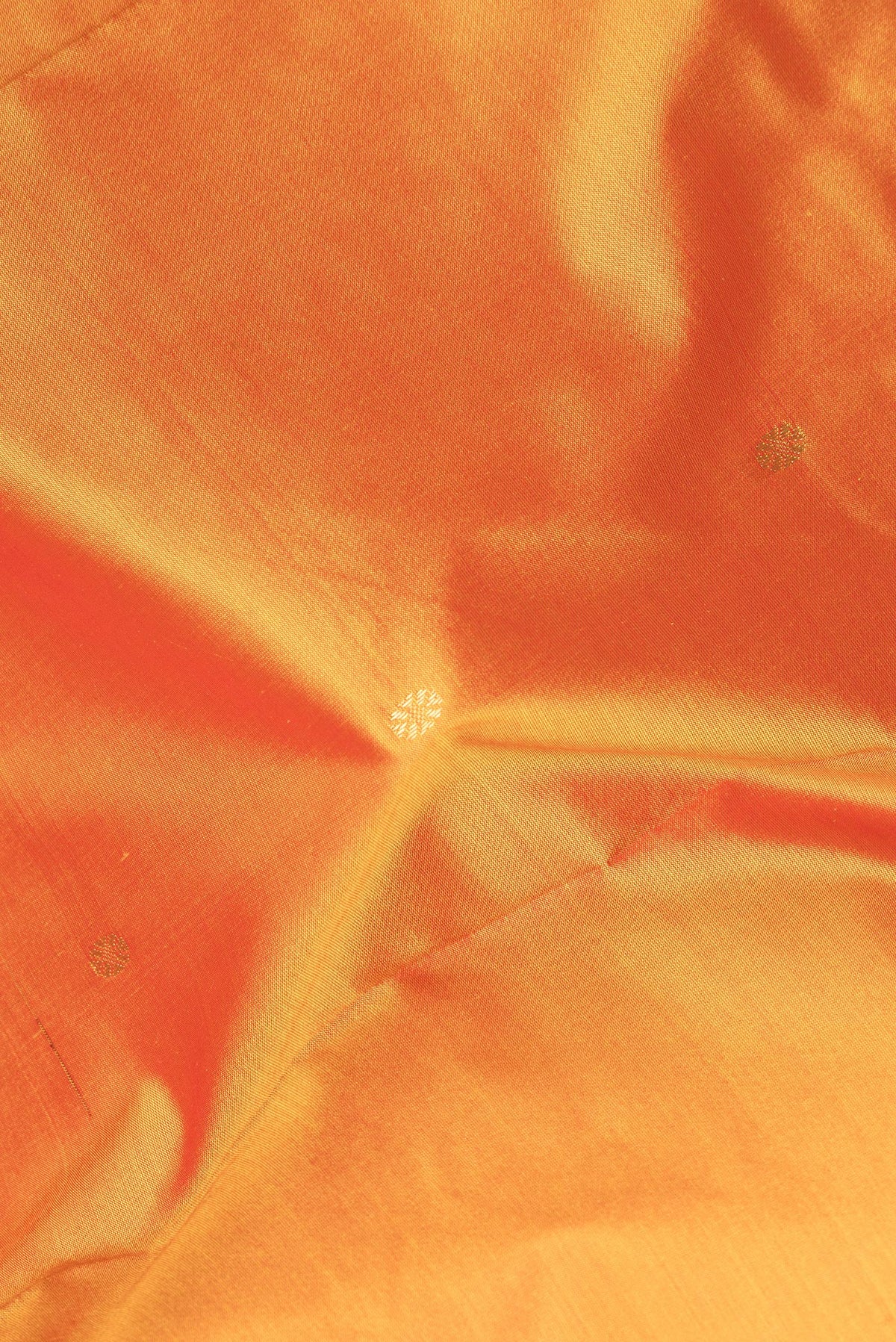 Close up of Pure Silk Yellow Bangalore Saree with Zari Butta on the body and Temple Border.  displaying folds