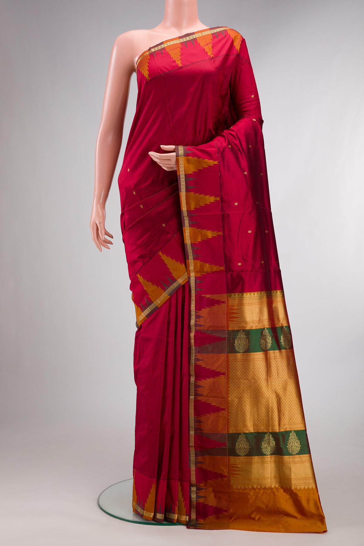 Pure Silk Maroon Bangalore Saree with Zari Butta on the body and Temple Border.  displayed on a mannequin