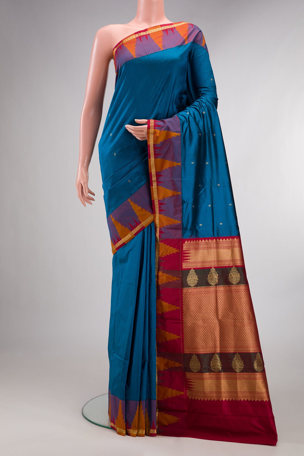 Pure Silk Peacock Blue Bangalore Saree with Zari Butta on the body and Temple Border.  displayed on a mannequin