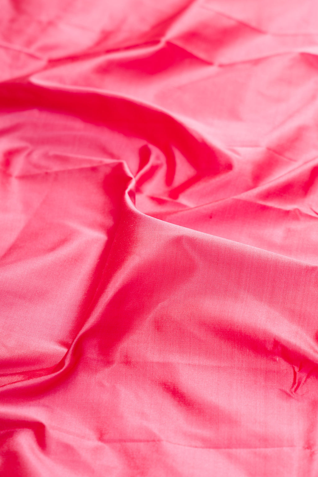 Close up of Pure Silk Pink Bangalore Saree with Plain Body and Zari Border.  displaying folds