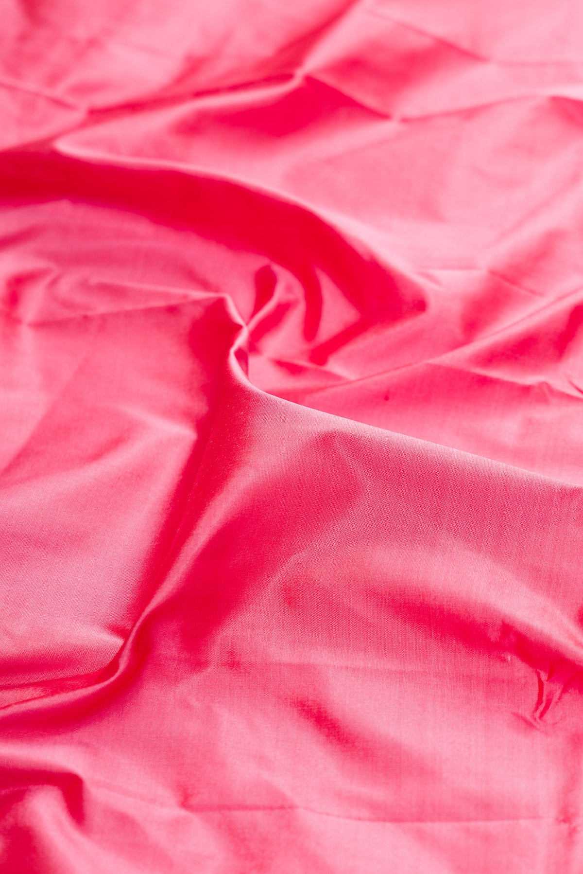 Close up of Pure Silk Pink Bangalore Saree with Plain Body and Zari Border.  displaying folds