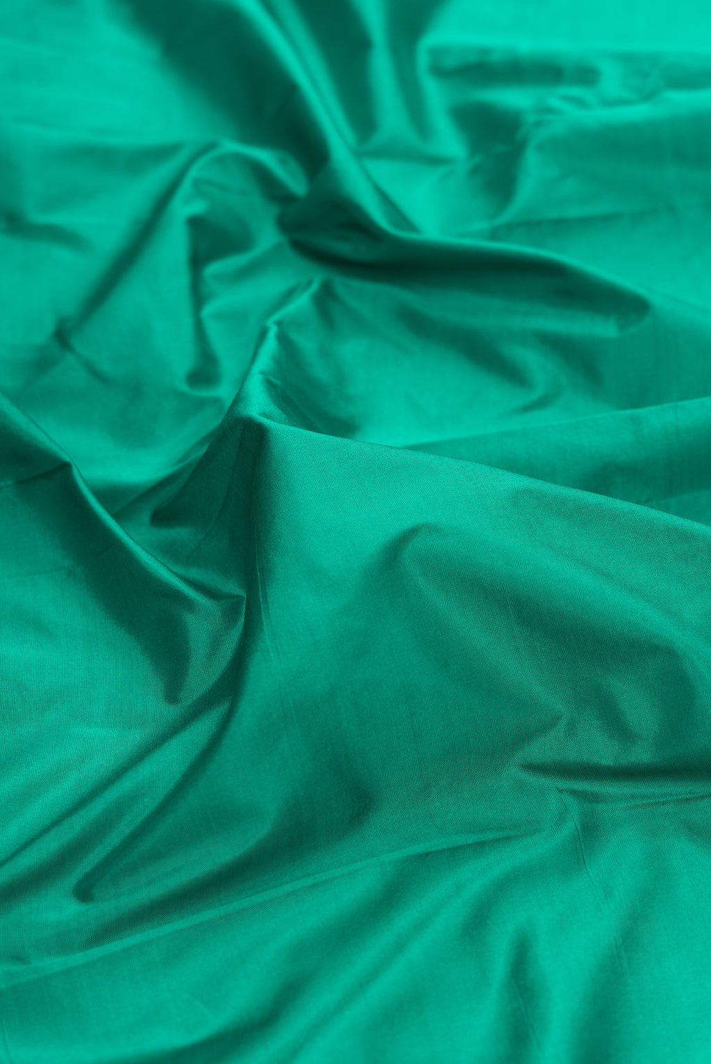 Close up of Pure Silk Green Bangalore Saree with Plain Body and Temple Border.  displaying folds
