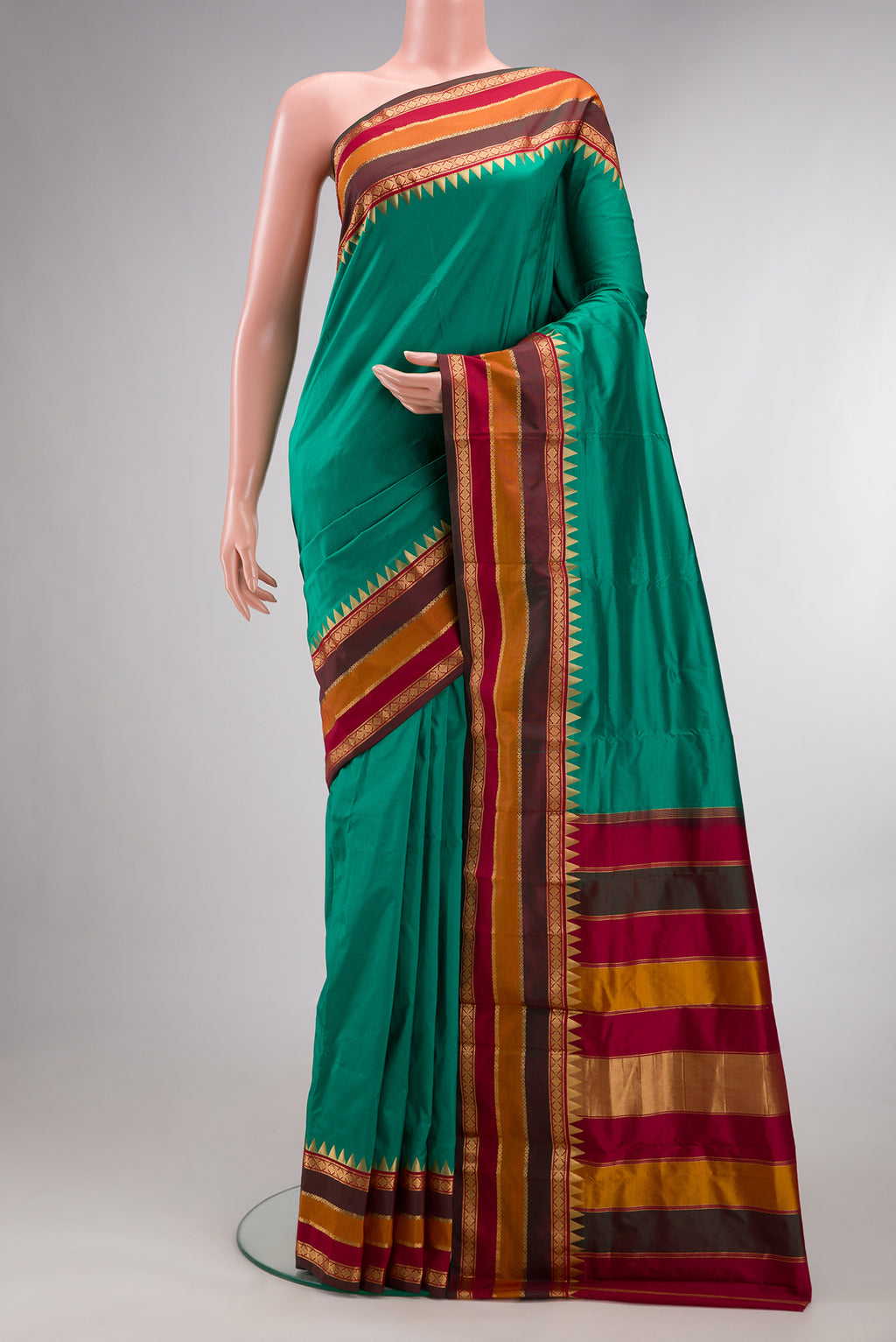 Pure Silk Green Bangalore Saree with Plain Body and Temple Border.  displayed on a mannequin