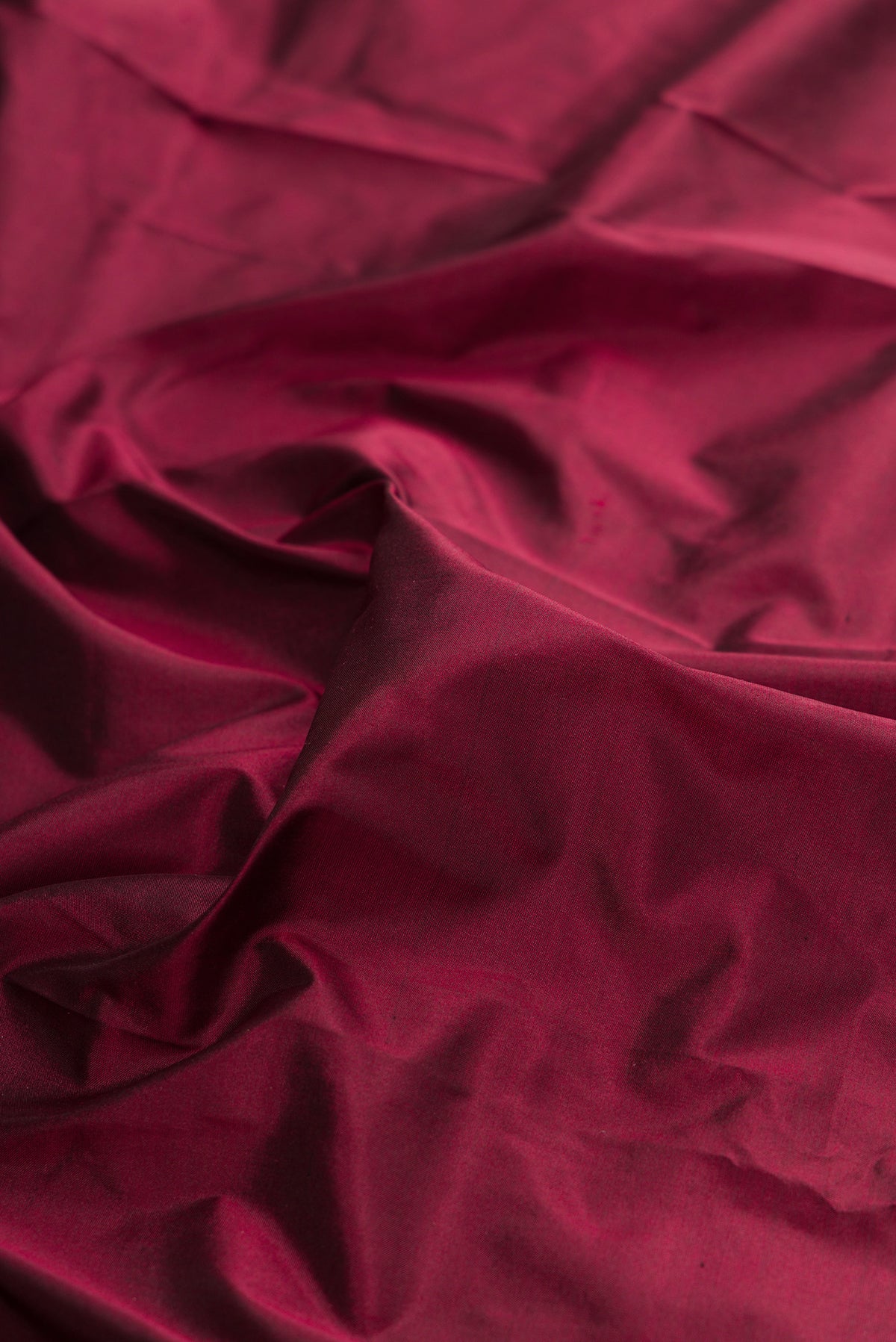 Close up of Pure Silk Maroon Bangalore Saree with Plain Body and Temple Border.  displaying folds