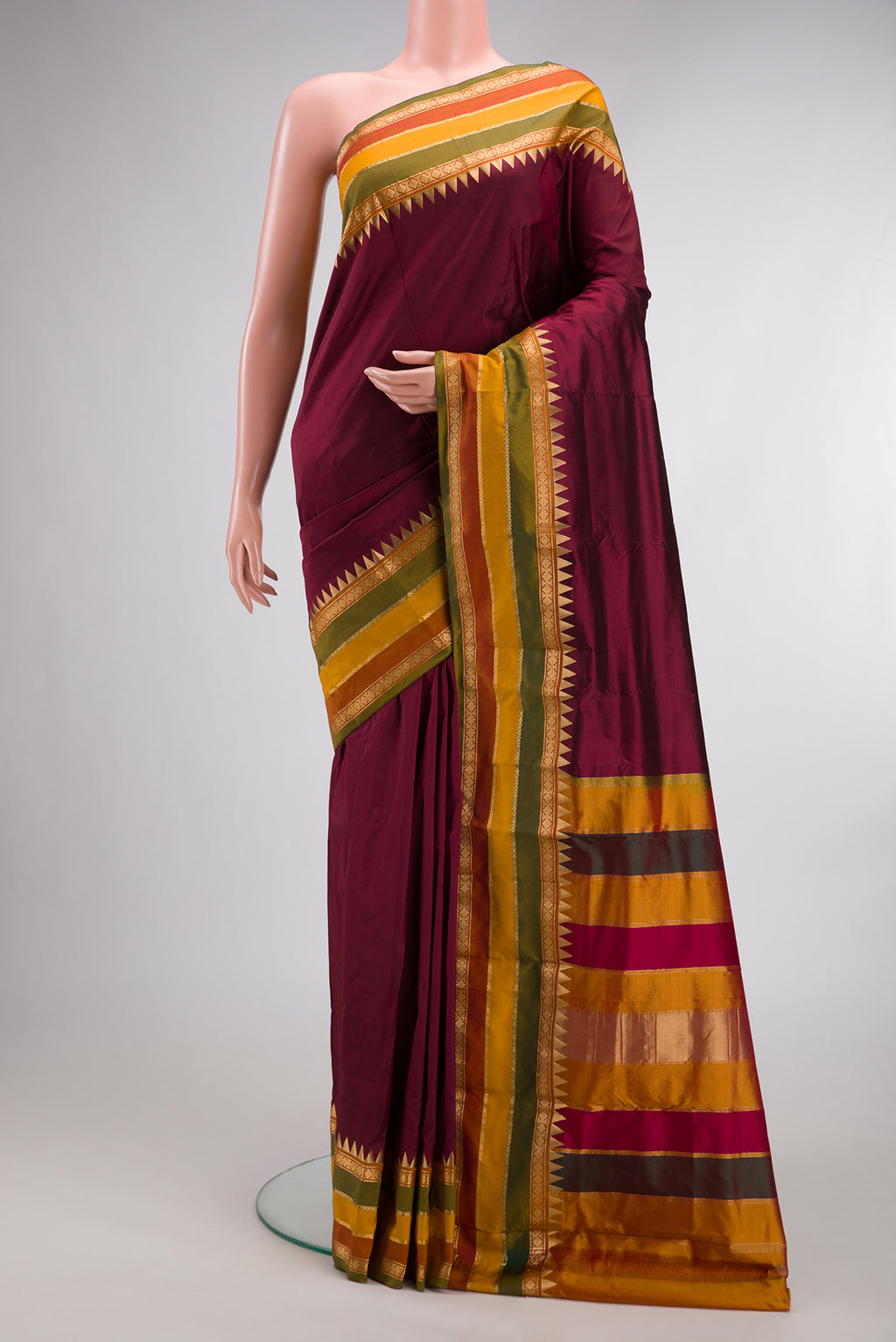 Pure Silk Maroon Bangalore Saree with Plain Body and Temple Border.  displayed on a mannequin