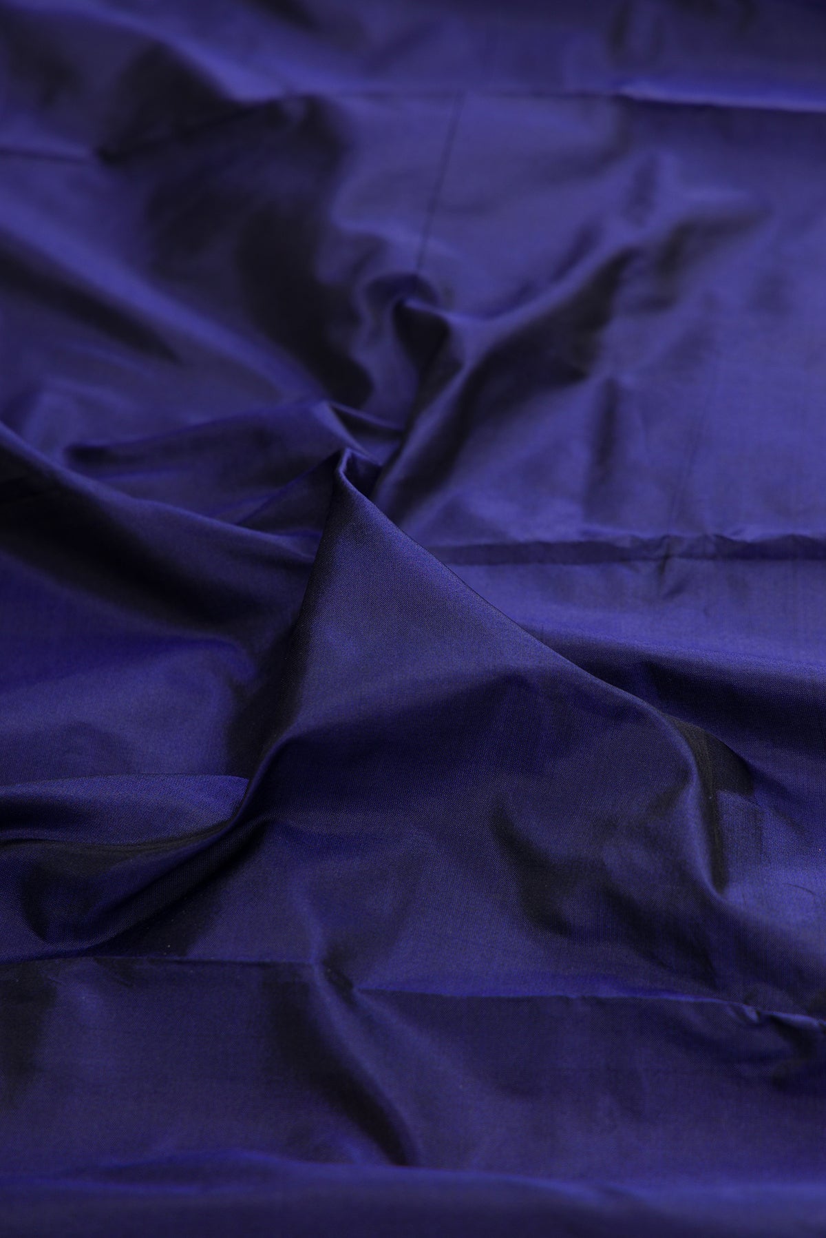 Close up of Pure Silk Navy Blue Bangalore Saree with Plain Body and Temple Border.  displaying folds