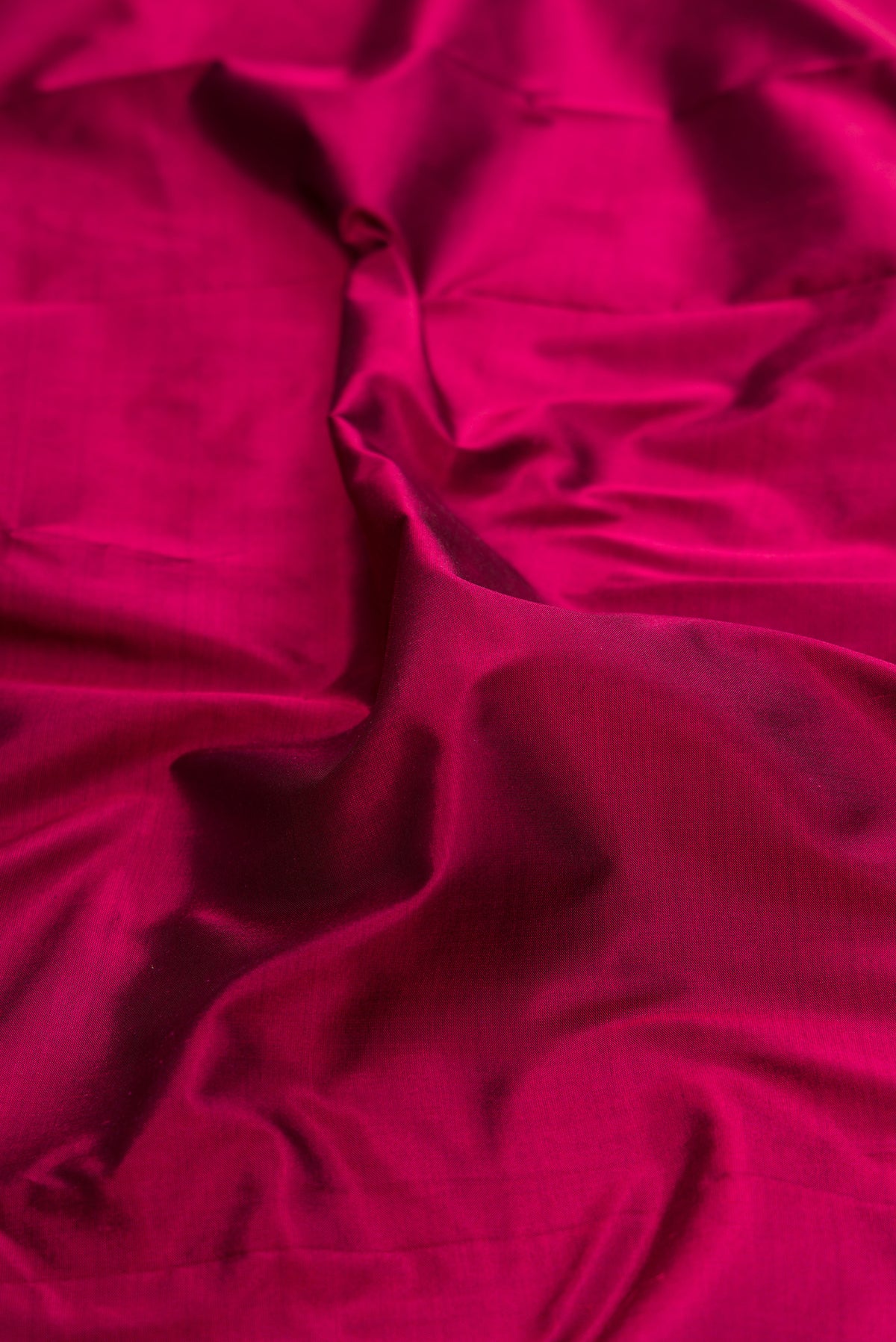 Close up of Pure Silk Maroon Bangalore Saree with Plain Body and Temple Border.  displaying folds