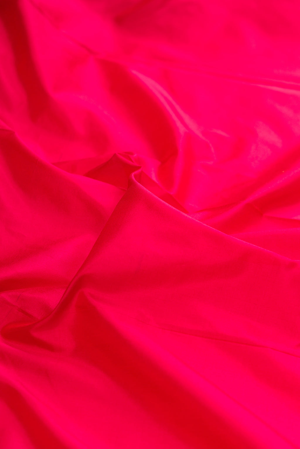 Close up of Pure Silk Dark Pink Bangalore Saree with Plain Body and Zari Border.  displaying folds