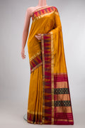 Pure Silk Mustard Bangalore Saree with Zari Butta on the body and Temple Border.  displayed on a mannequin