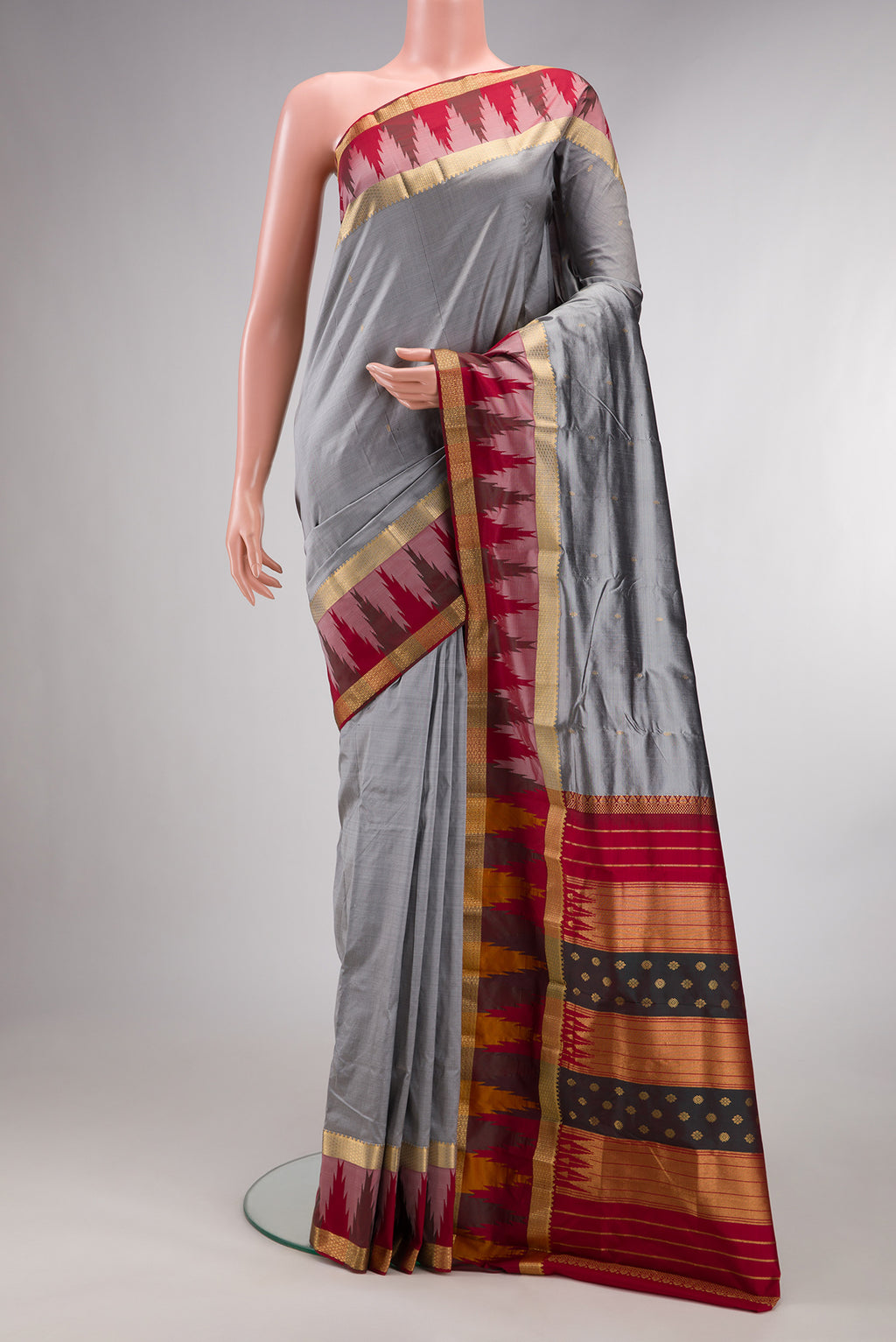 Pure Silk Grey Bangalore Saree with Zari Butta on the body and Temple Border.  displayed on a mannequin