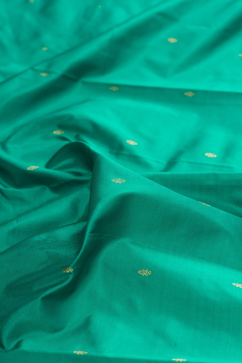Close up of Pure Silk Green Bangalore Saree with Zari Butta on the body and Temple Border.  displaying folds