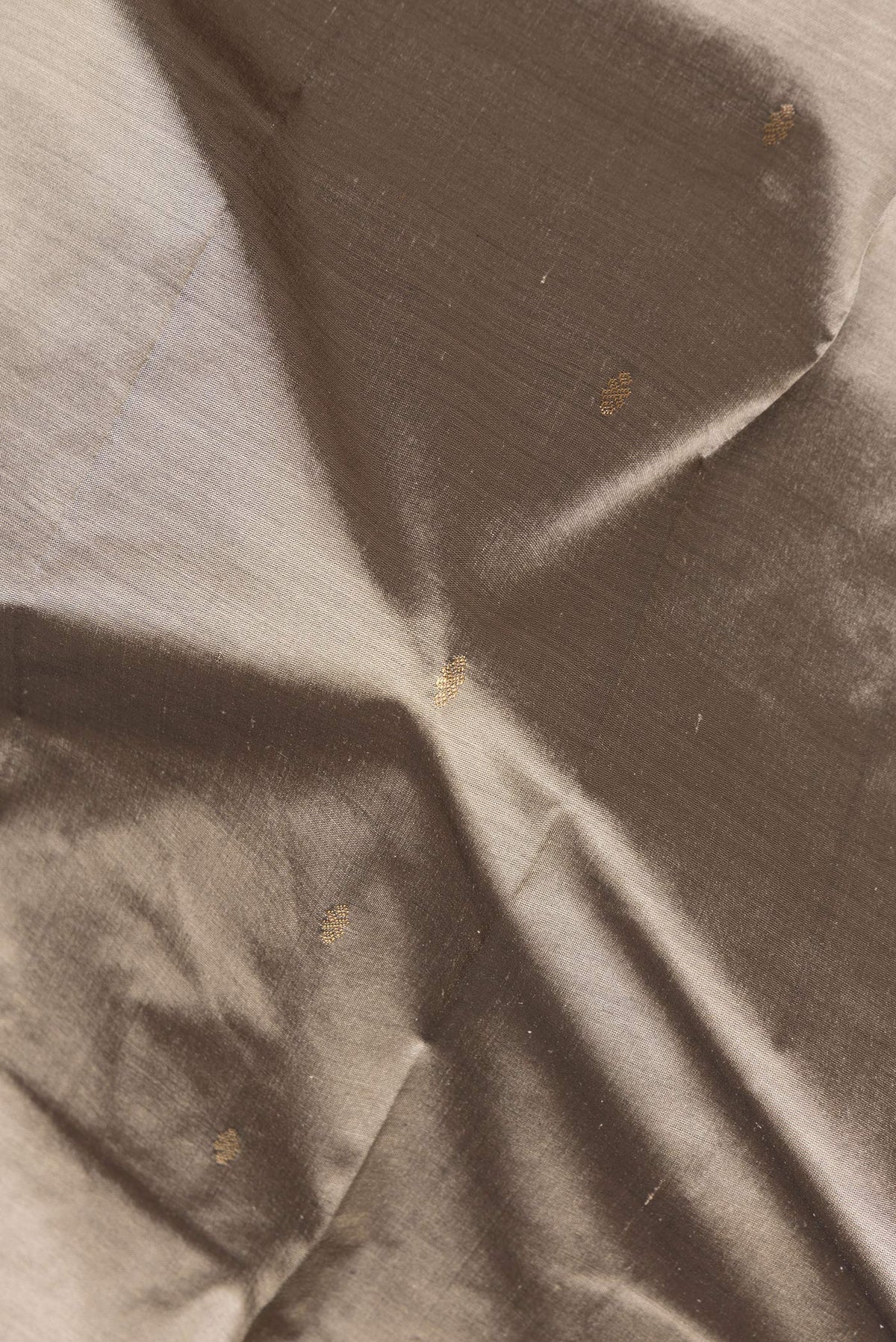 Close up of Pure Silk Grey Bangalore Saree with Zari Butta on the body and Temple Border.  displaying folds