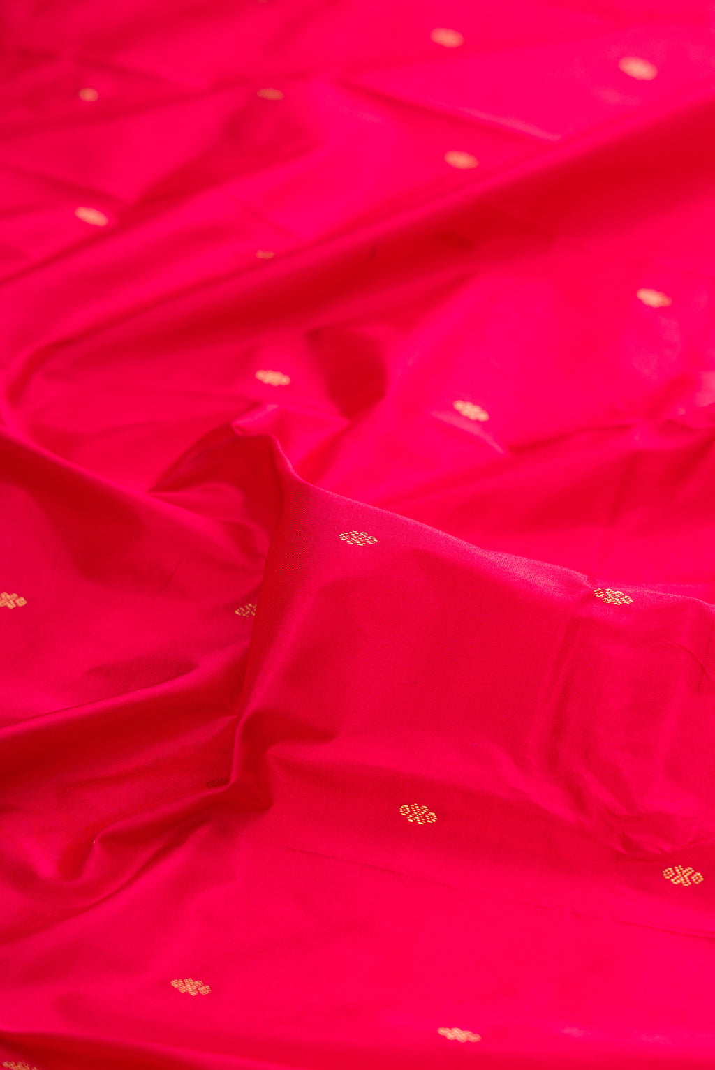 Close up of Pure Silk Red Bangalore Saree with Zari Butta on the body and Temple Border.  displaying folds