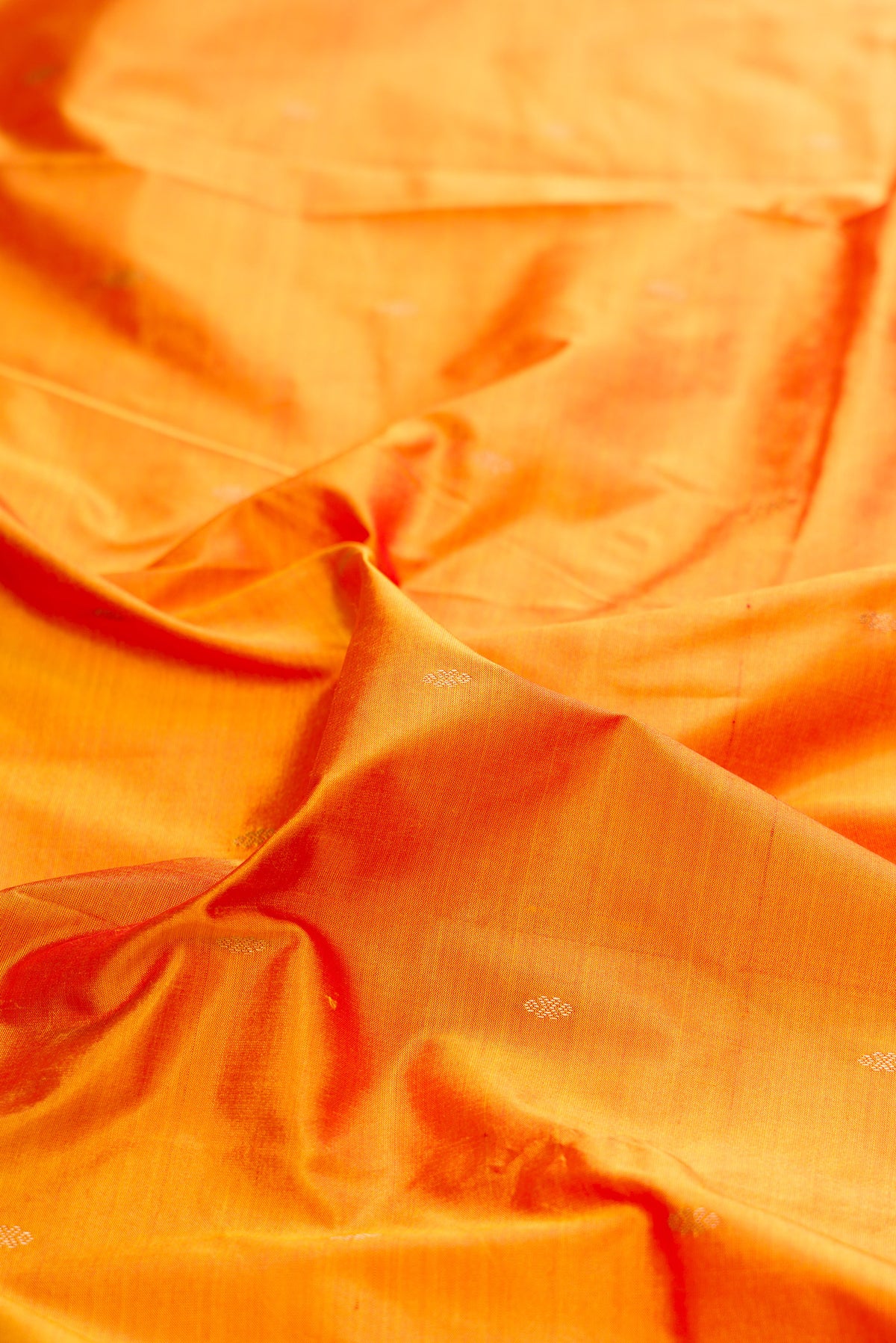 Close up of Pure Silk Mustard Dual Tone Bangalore Saree with Zari Butta on the body and Temple Border.  displaying folds
