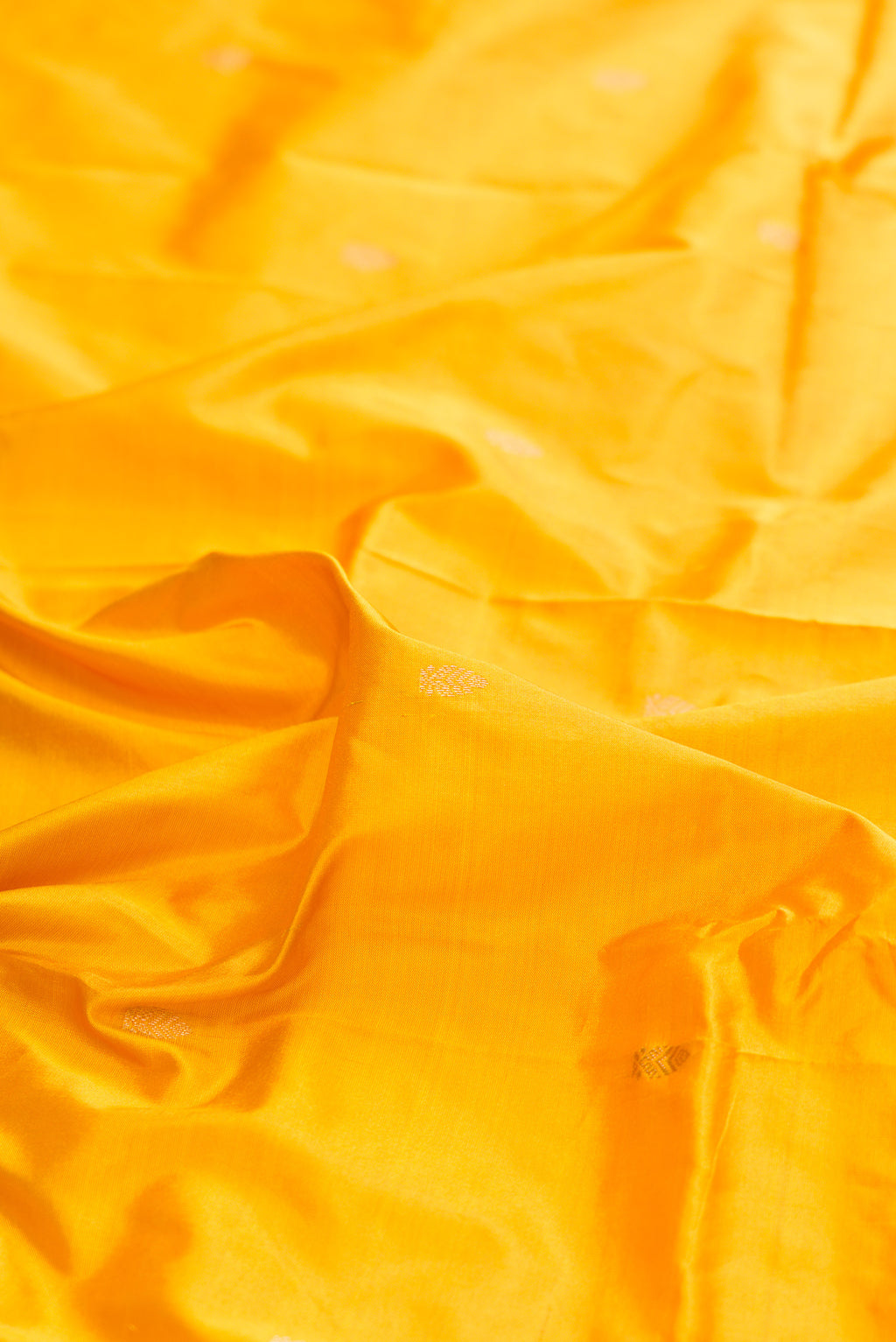 Close up of Pure Silk Yellow Bangalore Saree with Zari Butta on the body and Zari Border.  displaying folds