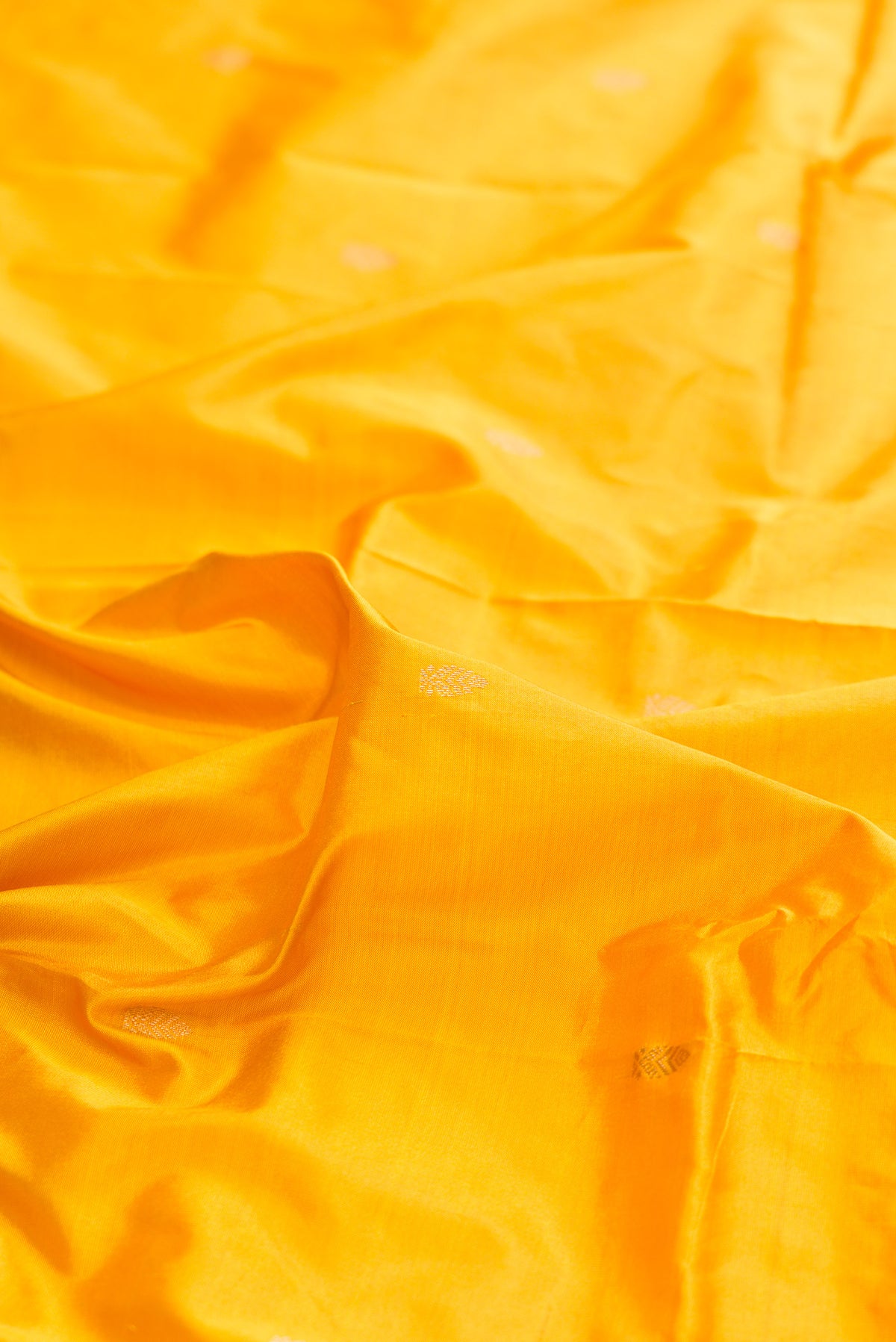Close up of Pure Silk Yellow Bangalore Saree with Zari Butta on the body and Zari Border.  displaying folds