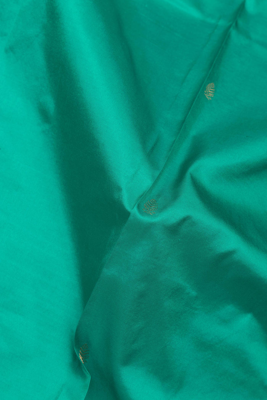 Close up of Pure Silk Green Bangalore Saree with Zari Butta on the body and Zari Border.  displaying folds