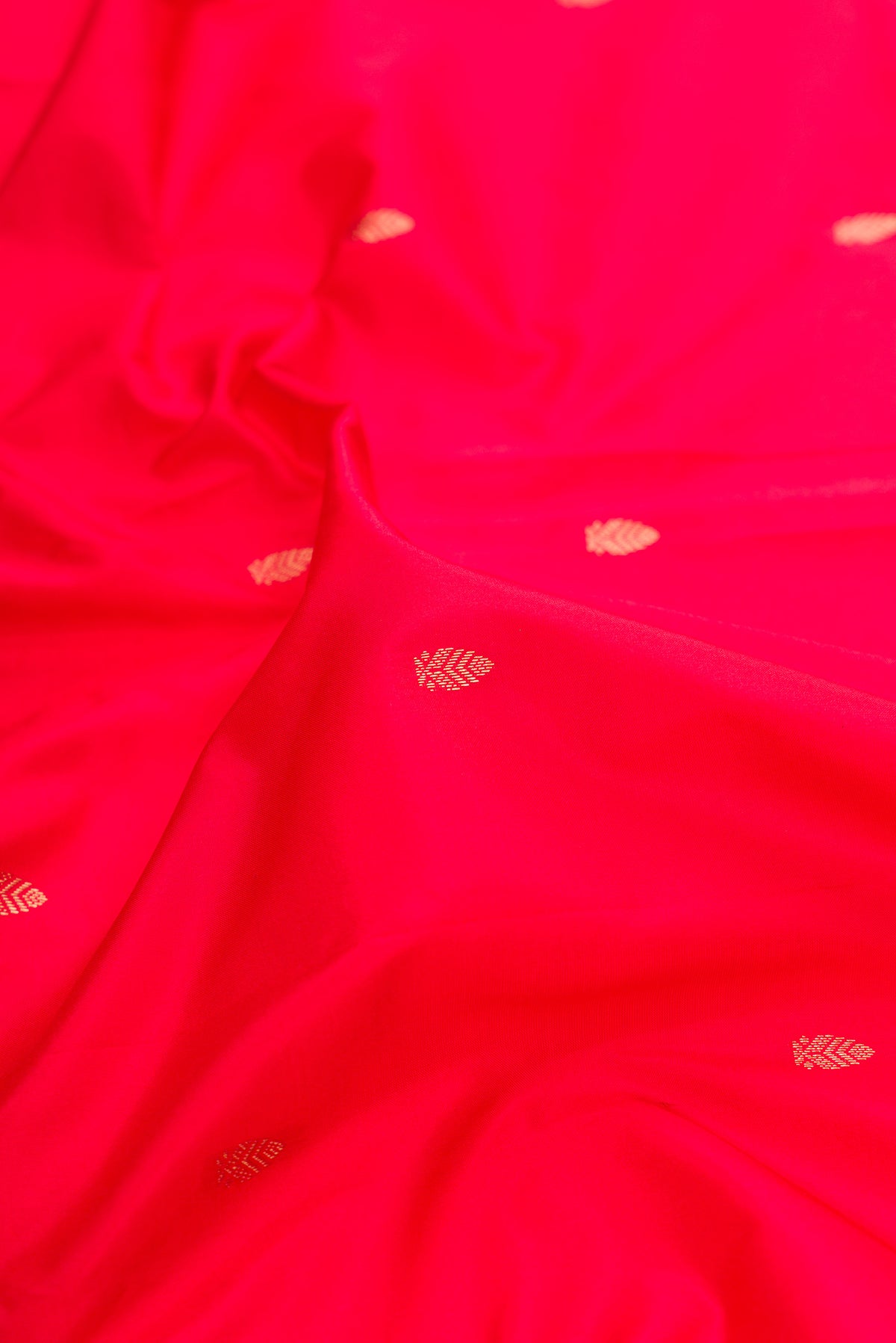 Close up of Pure Silk Red Bangalore Saree with Zari Butta on the body and Zari Border.  displaying folds