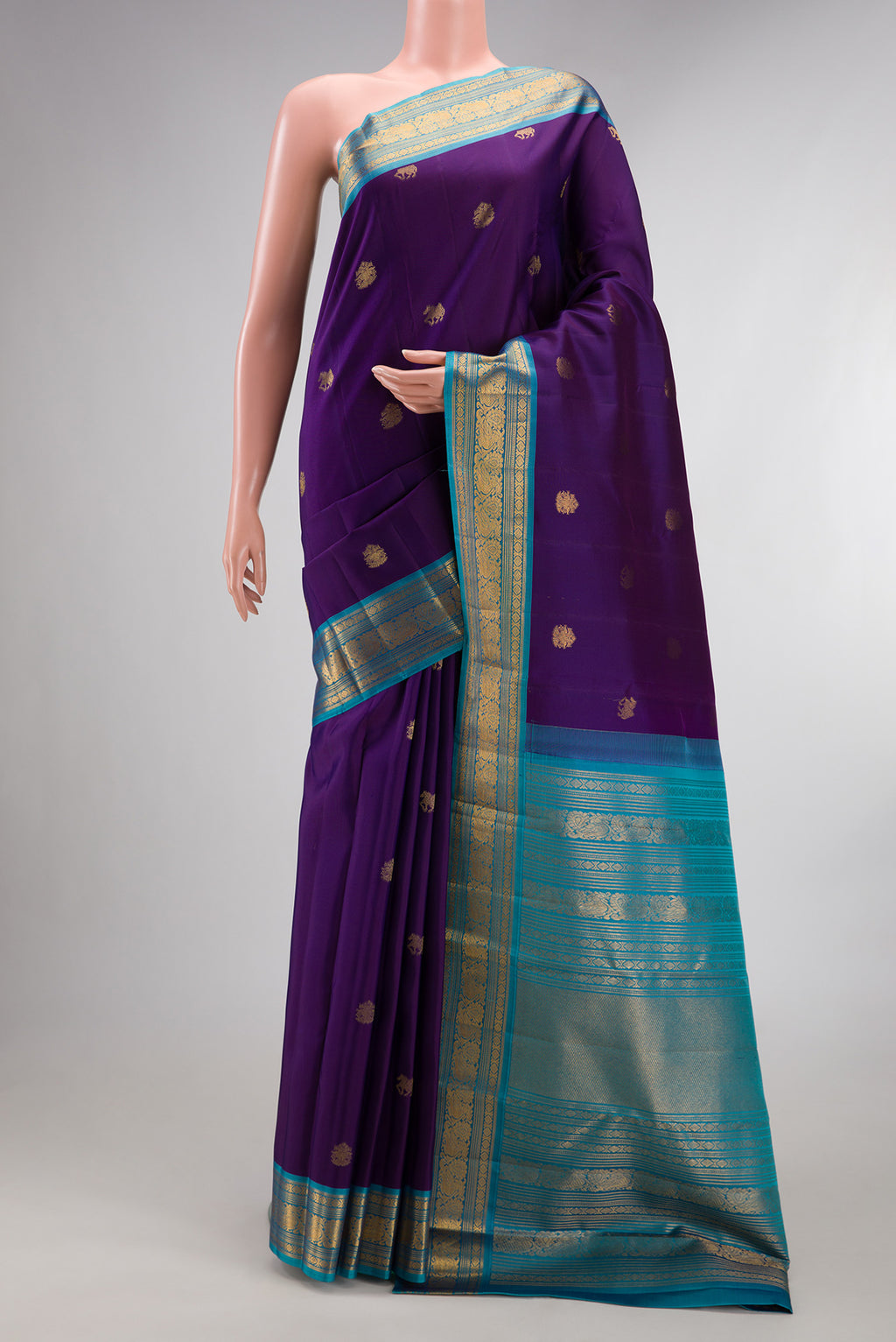 Pure Silk Violet Dual Tone Kanjivaram Saree with Zari Butta on the body and Zari Border.  displayed on a mannequin