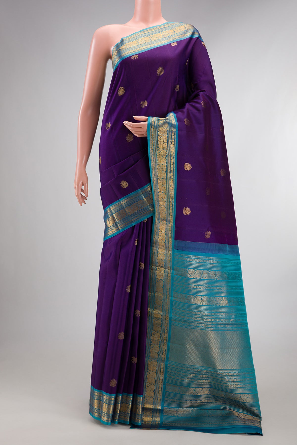 Pure Silk Violet Dual Tone Kanjivaram Saree with Zari Butta on the body and Zari Border.  displayed on a mannequin