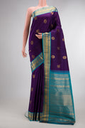 Pure Silk Violet Dual Tone Kanjivaram Saree with Zari Butta on the body and Zari Border.  displayed on a mannequin