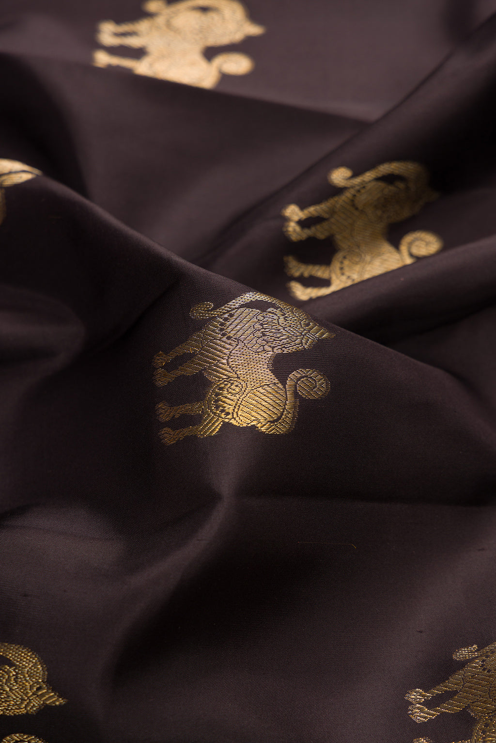 Close up of Pure Silk Coffee Brown Kanjivaram Saree with Zari Butta on the body and Zari Border.  displaying folds