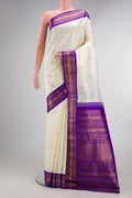 Pure Silk Off White Kanchipuram Saree with Zari Butta on the body and Zari Border.  displayed on a mannequin