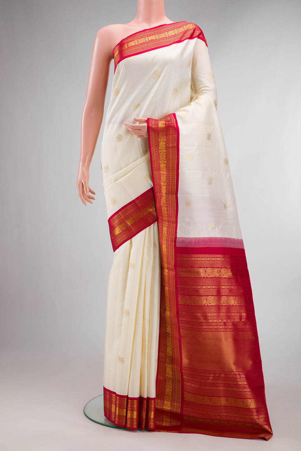 Pure Silk Off White Kanchipuram Saree with Zari Butta on the body and Zari Border.  displayed on a mannequin