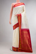 Pure Silk Off White Kanchipuram Saree with Zari Butta on the body and Zari Border.  displayed on a mannequin