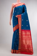 Pure Silk Blue Kanchipuram Saree with Zari Butta on the body and Zari Border.  displayed on a mannequin
