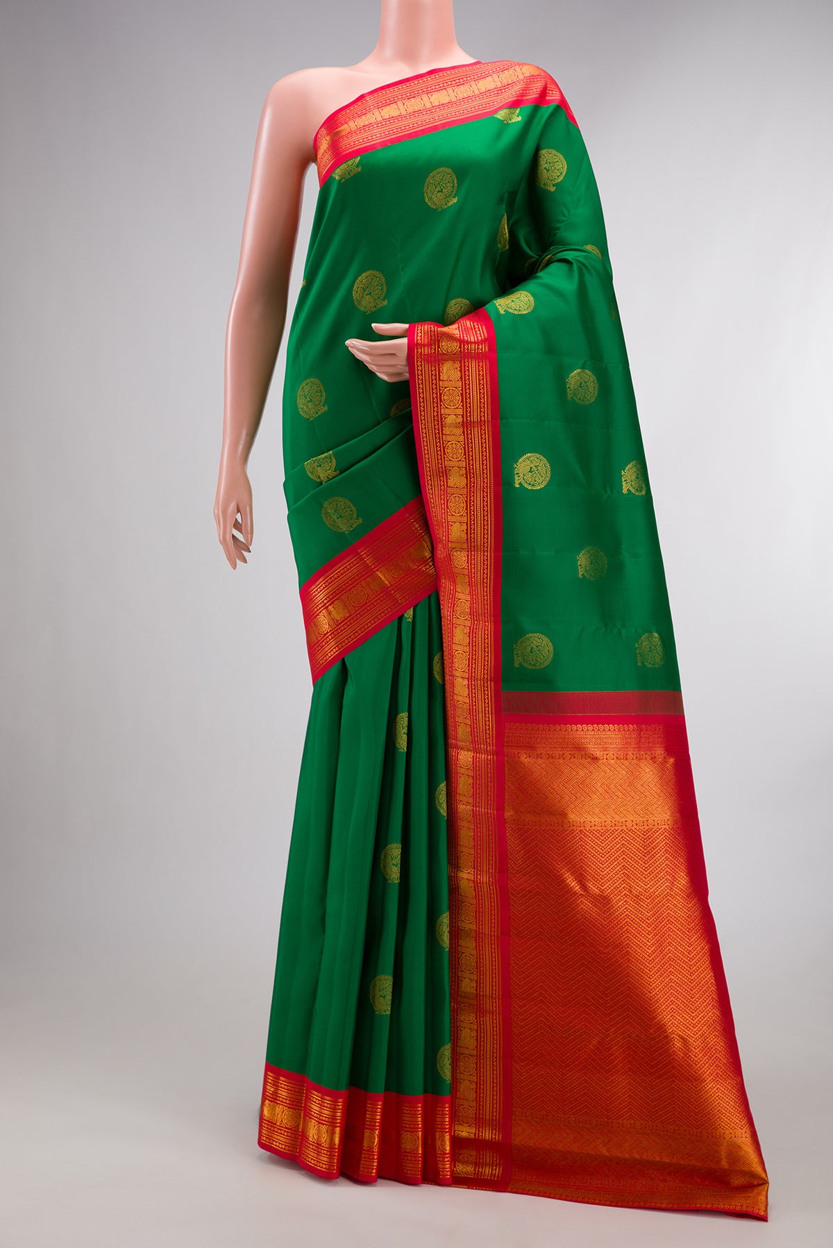 Pure Silk Green Kanchipuram Saree with Zari Butta on the body and Zari Border.  displayed on a mannequin