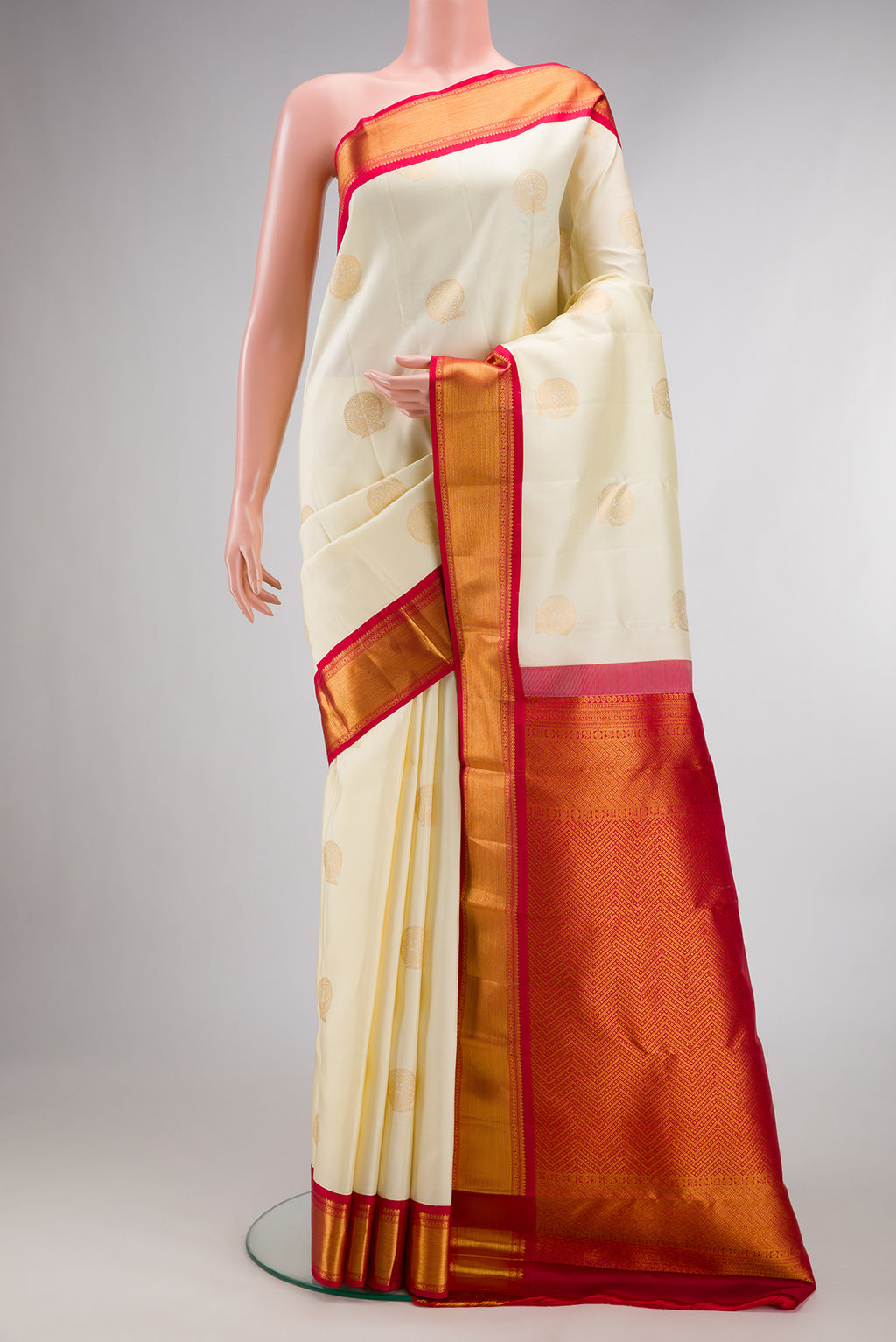 Pure Silk Cream Kanchipuram Saree with Zari Butta on the body and Zari Border.  displayed on a mannequin