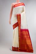 Pure Silk Off White Kanchipuram Saree with Zari Butta on the body and Zari Border.  displayed on a mannequin