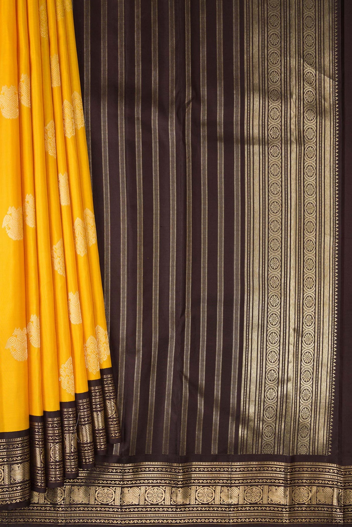 Pleats and pallu of Pure Silk Yellow Kanchipuram Saree with Zari Butta on the body and Zari Border. 