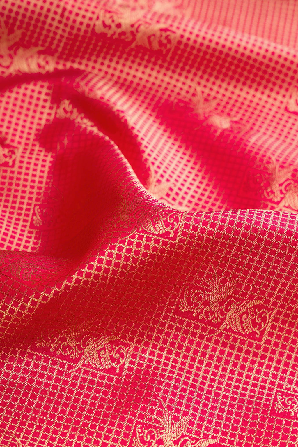 Close up of Pure Silk Dark Pink Dual Tone Kanchipuram Saree with Zari Brocade on the body and Zari Border.  displaying folds