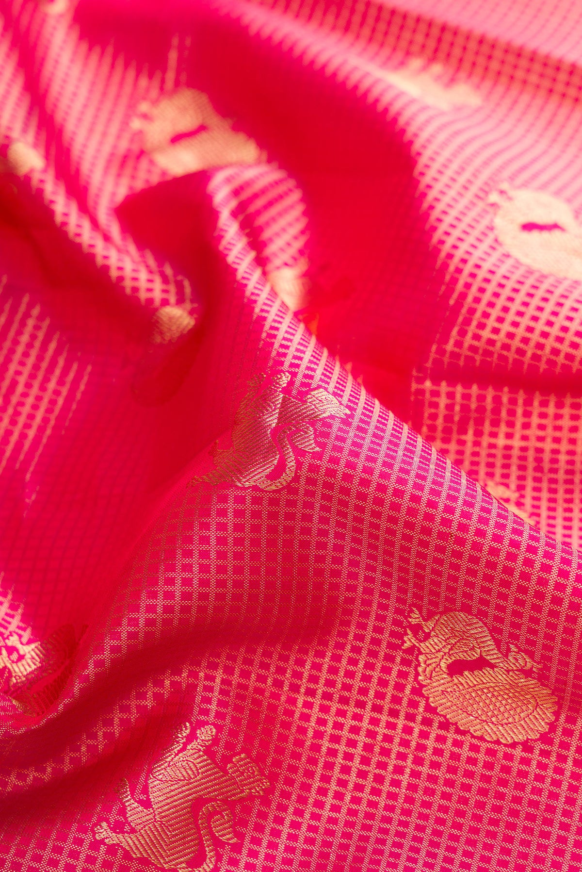 Close up of Pure Silk Dark Pink Dual Tone Kanchipuram Saree with Zari Brocade on the body and Zari Border.  displaying folds