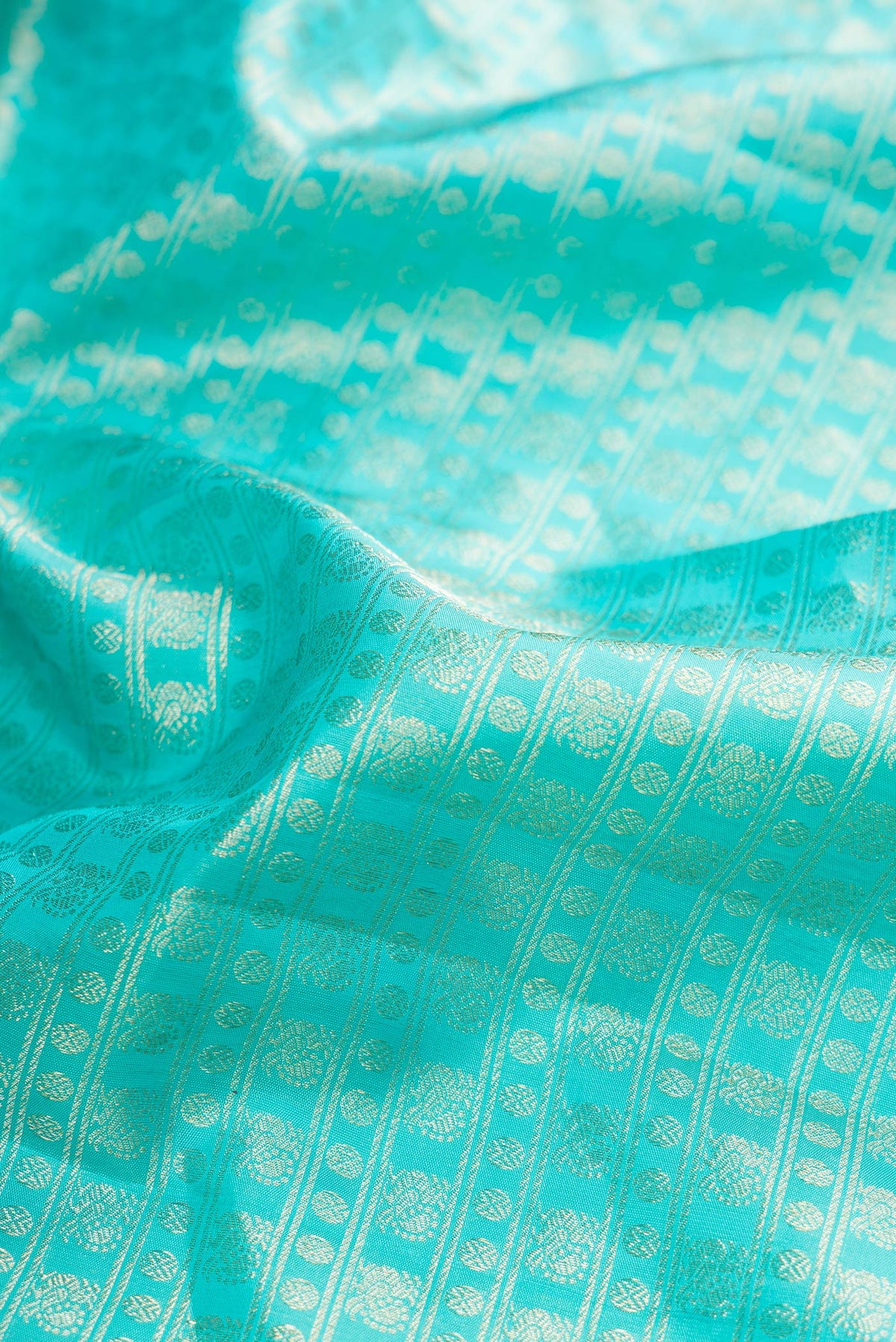 Close up of Pure Silk Turquoise Dual Tone Kanchipuram Saree with Zari Brocade on the body and Fancy Border.  displaying folds