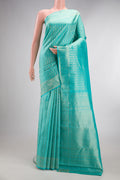 Pure Silk Turquoise Dual Tone Kanchipuram Saree with Zari Brocade on the body and Fancy Border.  displayed on a mannequin